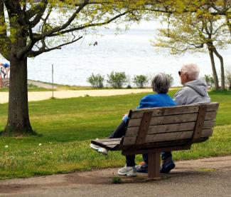 woman in blue shirt sitting on brown wooden bench by Joe Zlomek courtesy of Unsplash.