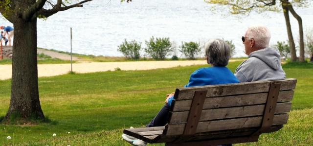 woman in blue shirt sitting on brown wooden bench by Joe Zlomek courtesy of Unsplash.